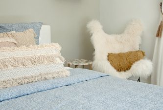 Beachy Boho Bedroom cover featuring a bed with blue bed linen by DKOR Interiors.