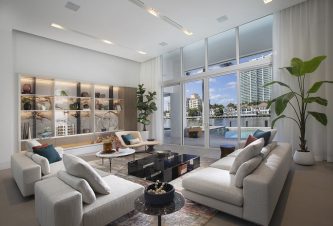 Dynamic living room design featuring built-in wall shelving with porcelain backsplash, accent wall, and an ocean view by DKOR Interiors.