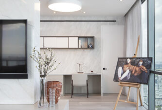Miami Edgewater penthouse with Modern Asian-inspired design, featuring an office space adorned with canvas art.