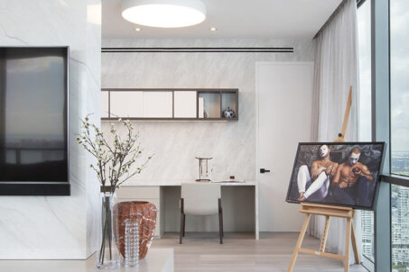 Miami Edgewater penthouse with Modern Asian-inspired design, featuring an office space adorned with canvas art.