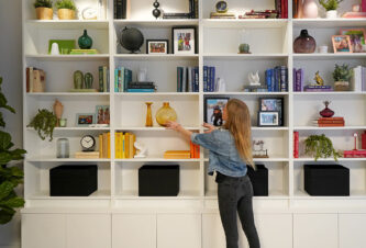A garage turned into a playroom featuring built-in bookcases with storage.