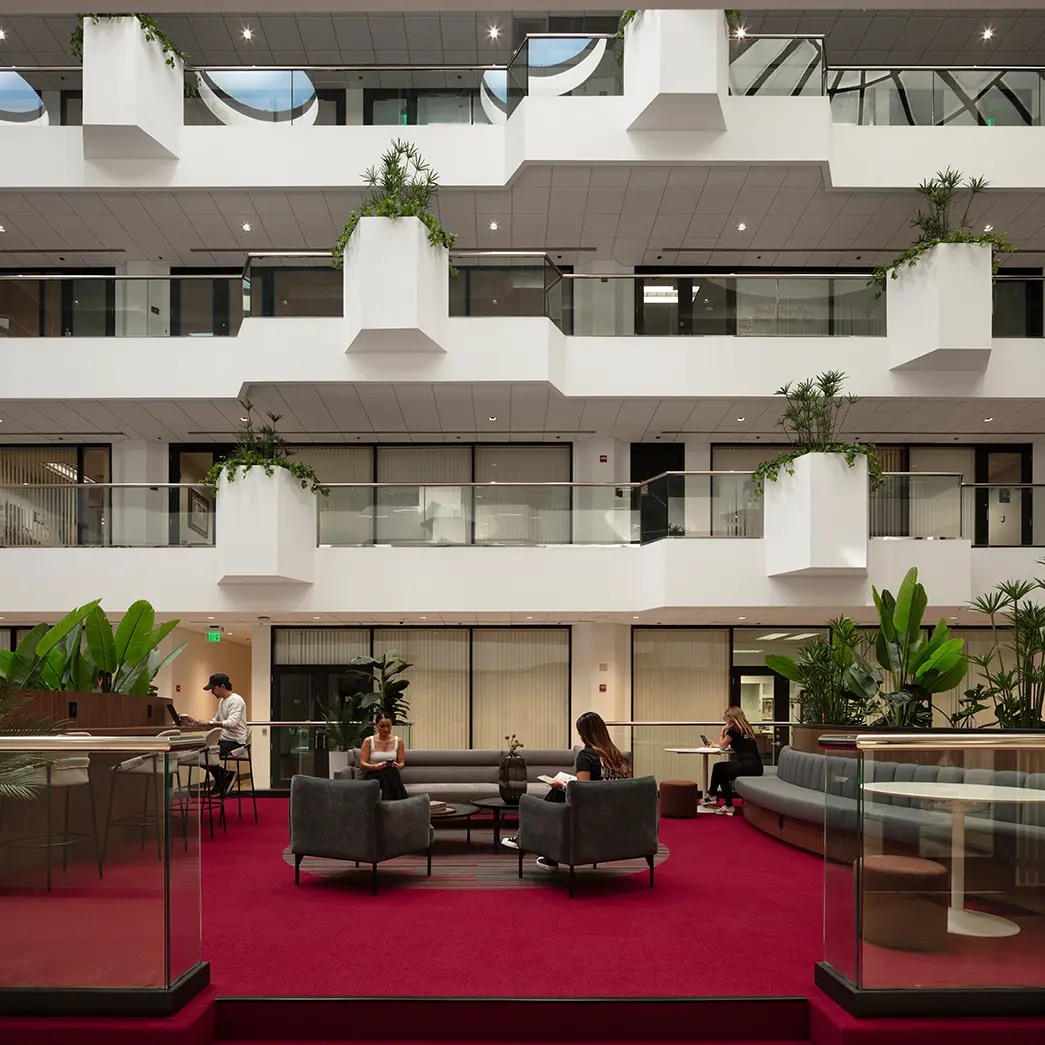Seating and Desk Areas in a Lounge Space for an Office with Shared Amenities