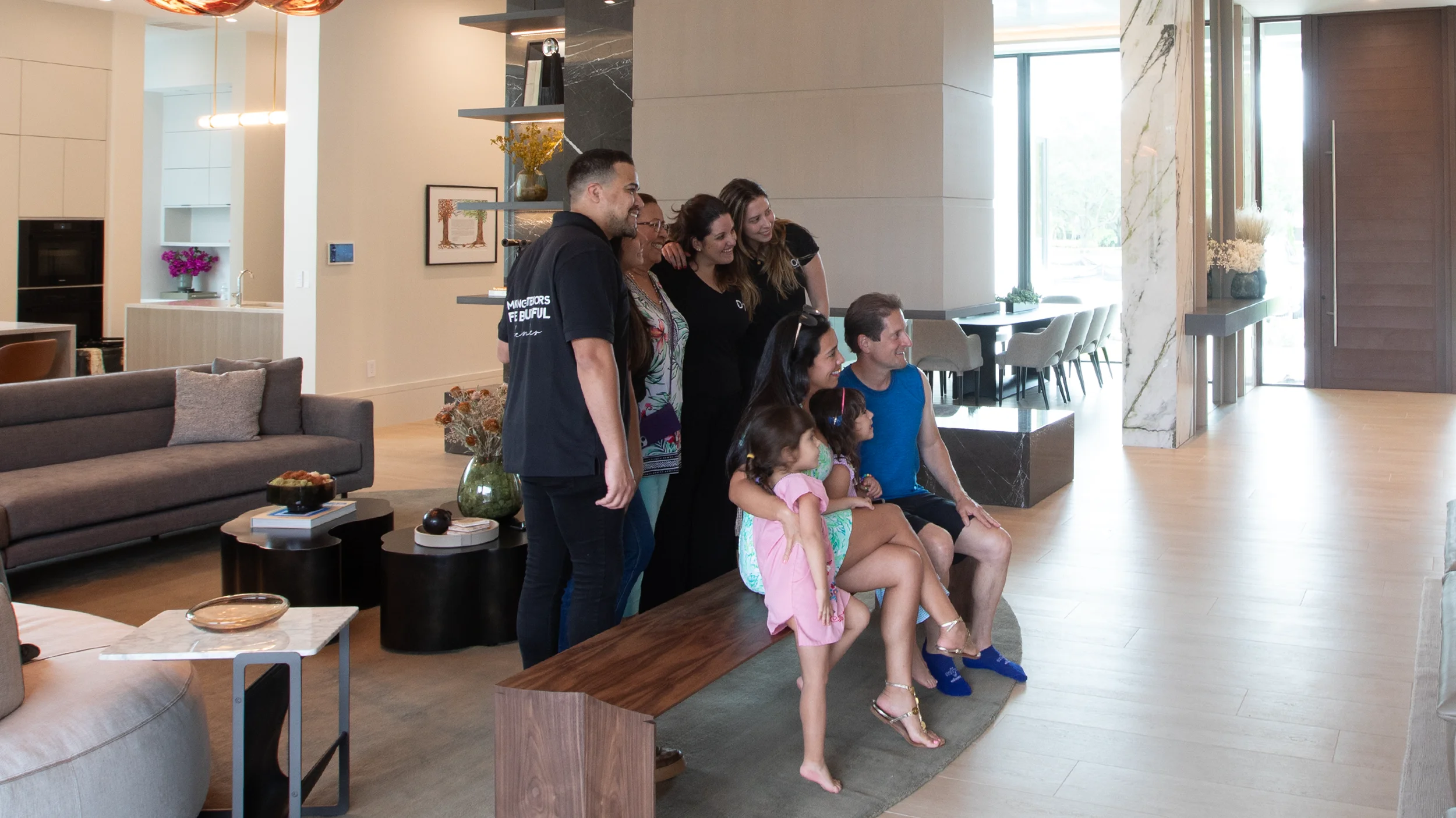 Smiling family in cozy living room, sharing testimonial for residential design firm.