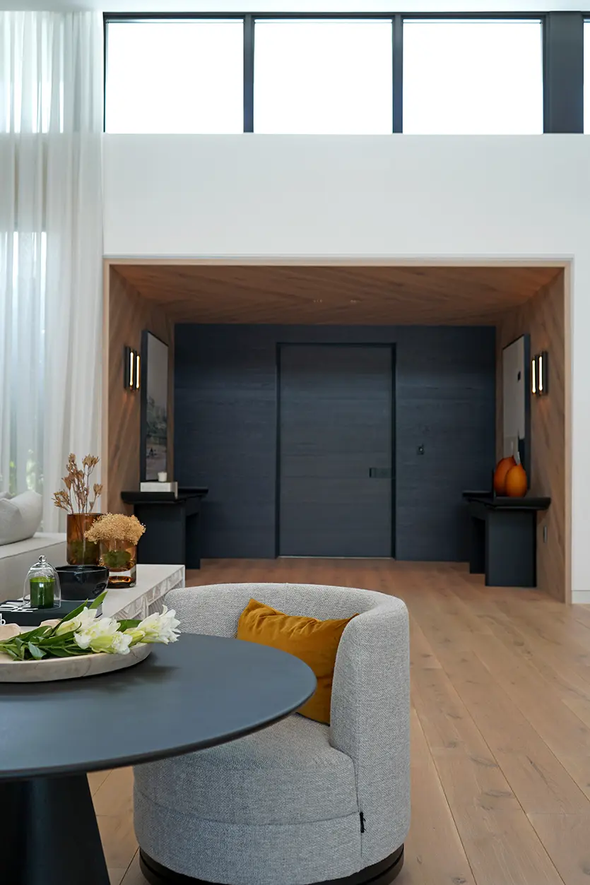 Contemporary Entry Foyer with Black Doors and Wood Wrapping