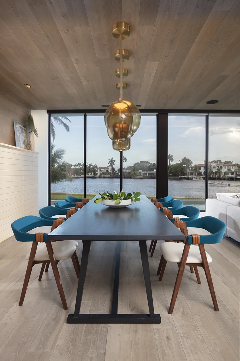 Dining room with a pop of color in a Florida waterfront residence