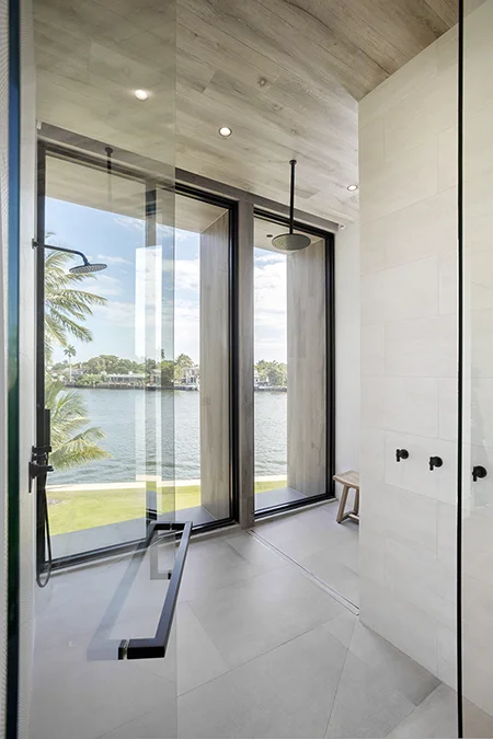 Glass-Enclosed Master Bathroom Shower with Waterfront Views