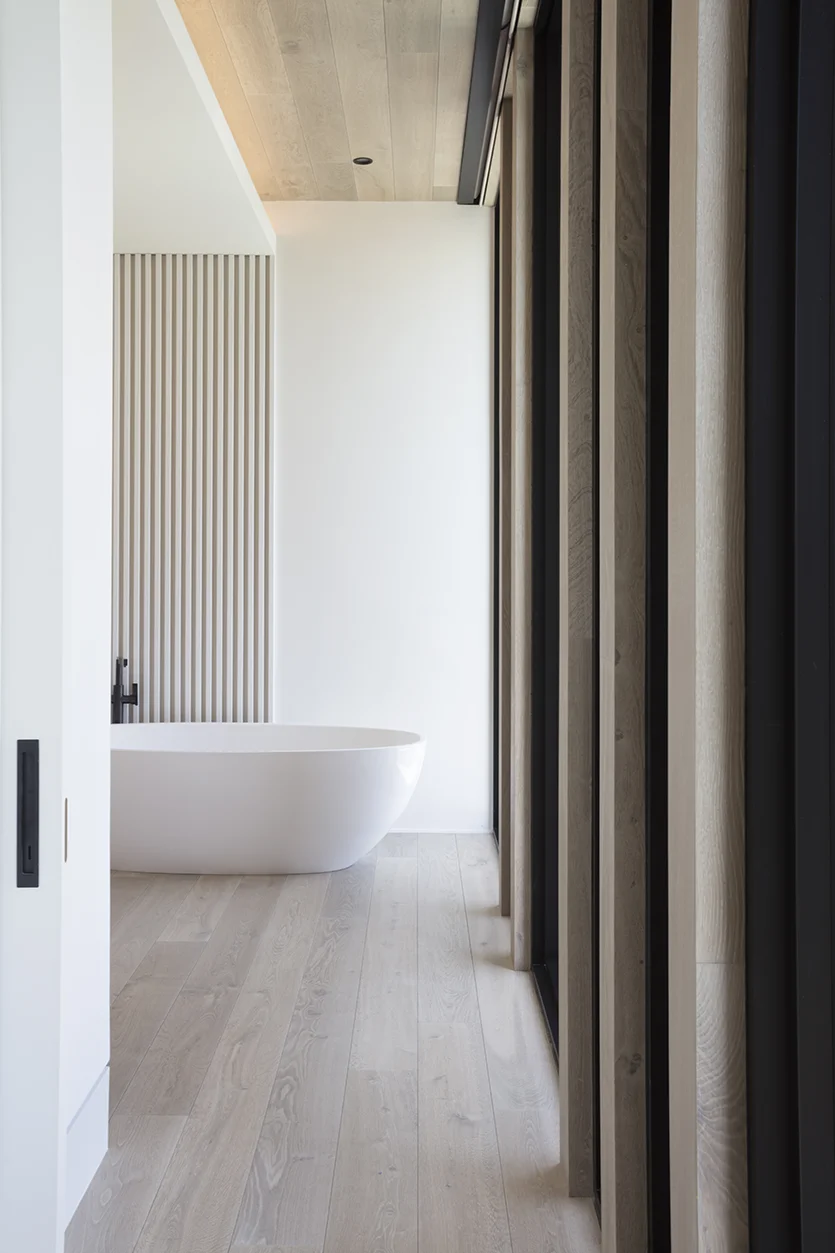 Hallway Leading to Luxury Master Bathroom with Tub