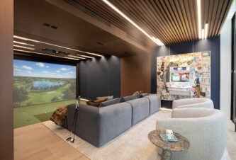 Golf simulator room and arcade lounge in a Venetian Islands home by DKOR Interiors