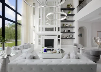 Luxury transitional living room with round chandelier grouping and custom built-ins by residential design firm in Boca Raton, Florida