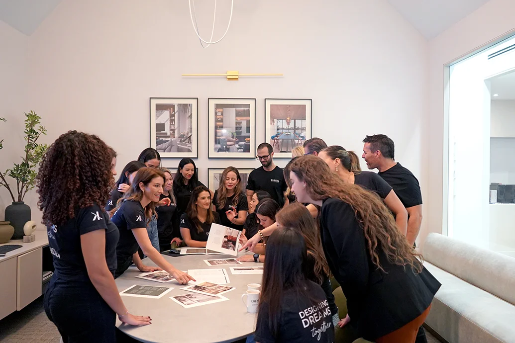 Miami interior design team reviewing project materials around a table in a bright design studio