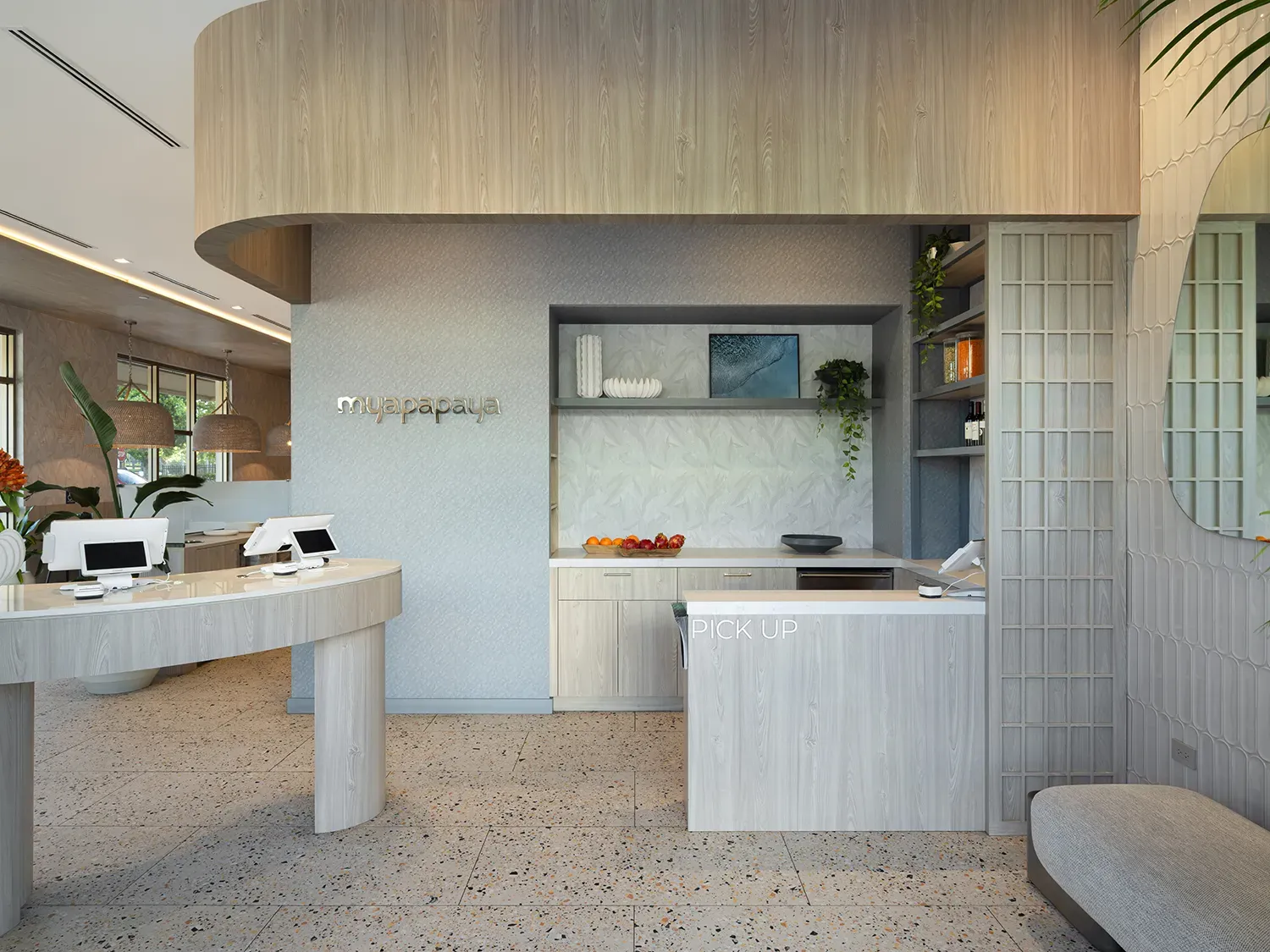 Fort Lauderdale restaurant pickup area with curved light wood counters, open shelving, terrazzo flooring, and branded signage