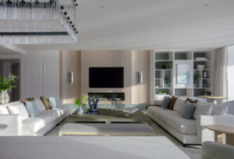 Living room with ocean view in a Bal Harbour luxury home renovation by DKOR Interiors.