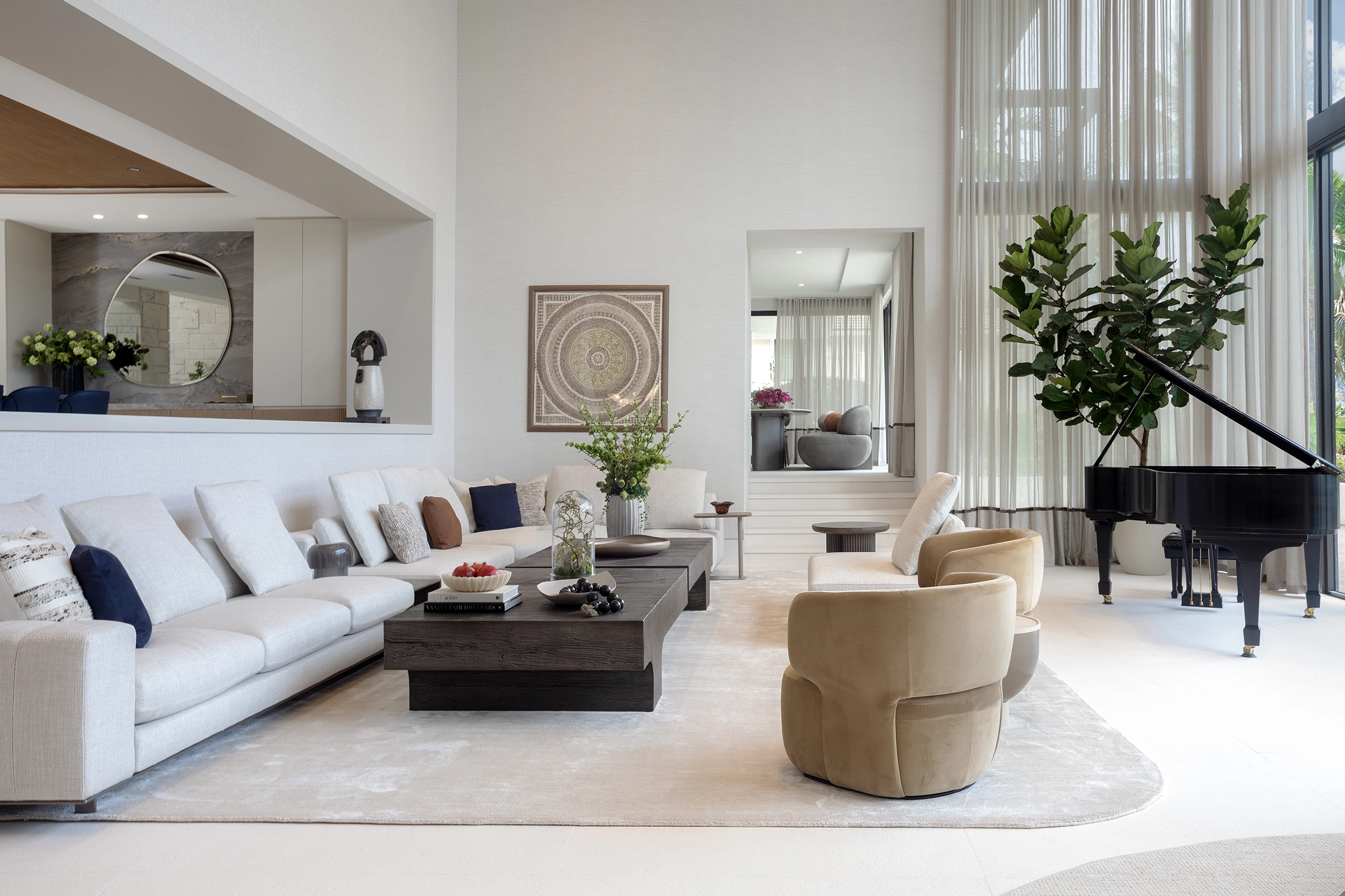 Serene living room with a grand piano, neutral tones, and warm wood finishes in a Coral Gables luxury home renovation.