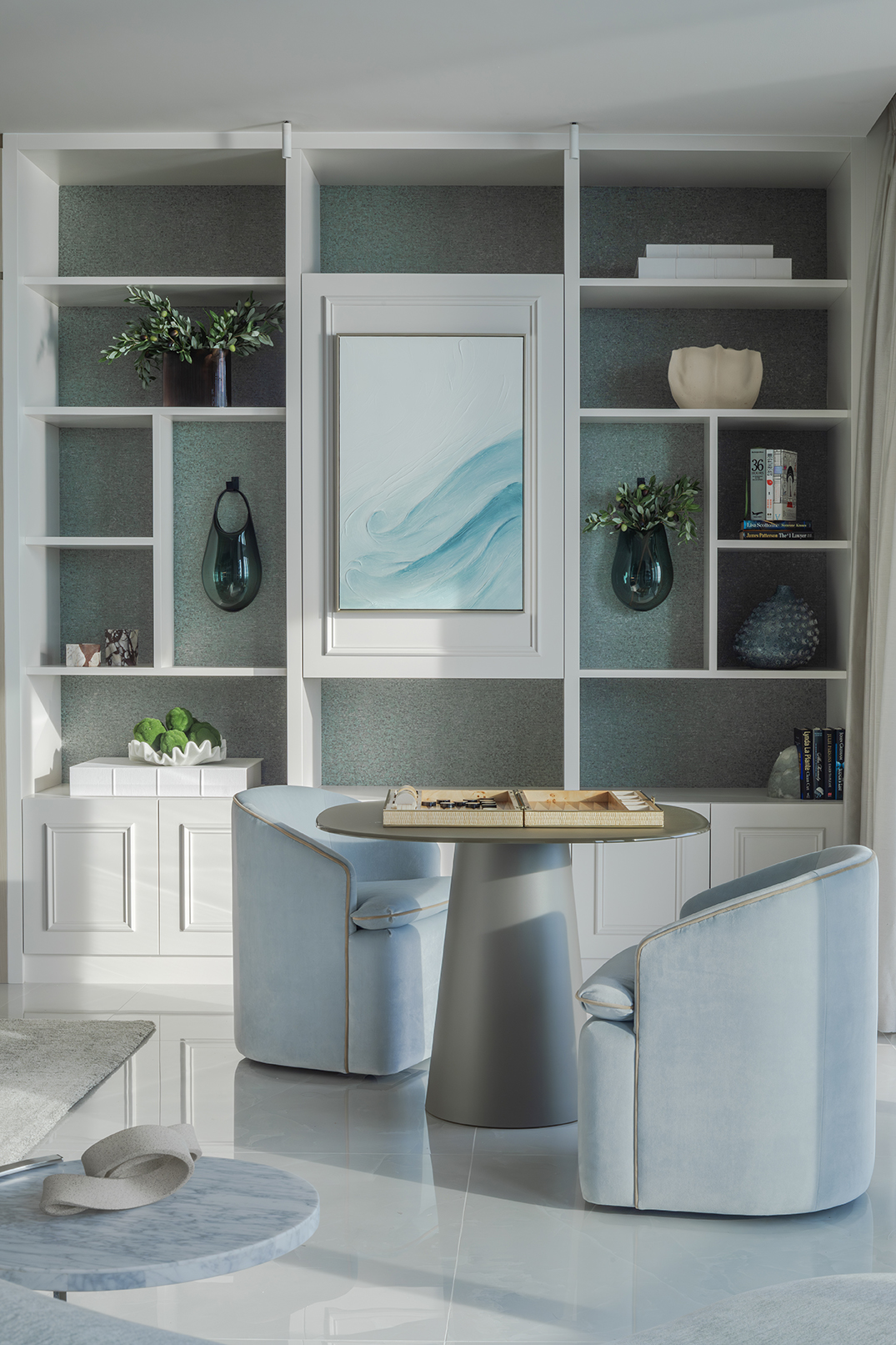 Luxurious interior materials including cream marble, wheat lacquer, and engineered wood in a modern coastal home.