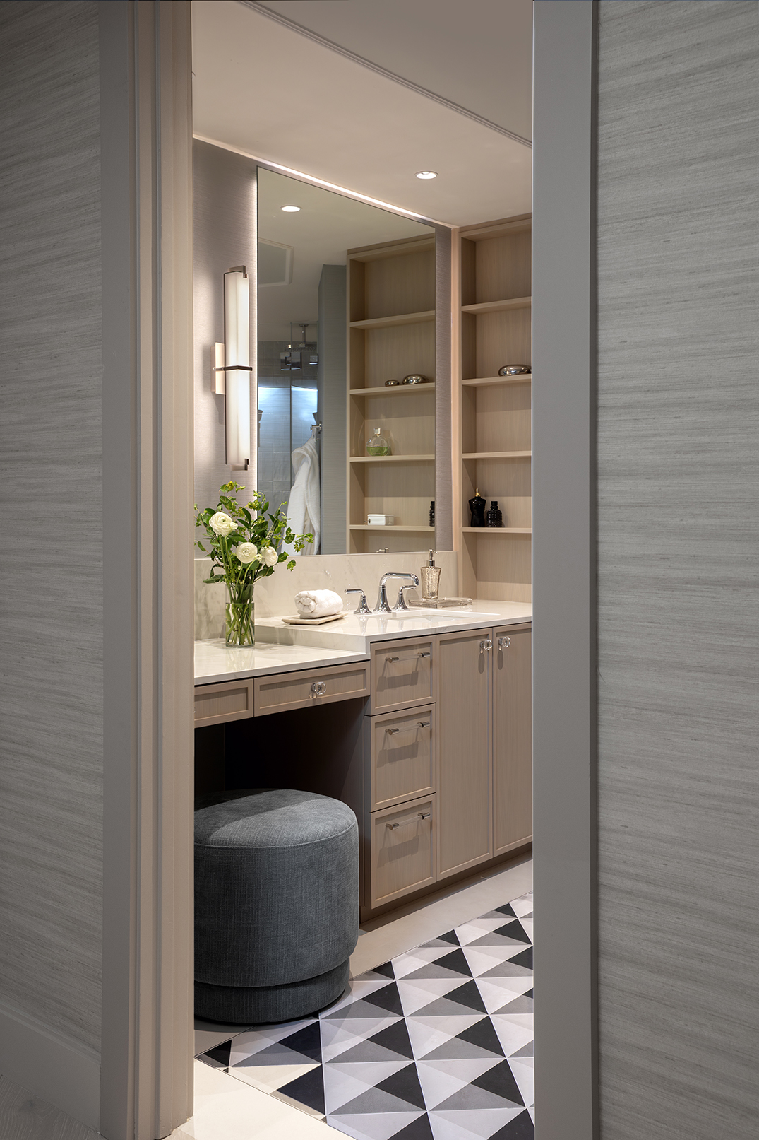Modern coastal interior design elements, including a marble kitchen island, a vanity nook, and a luxury bedroom with textured walls.