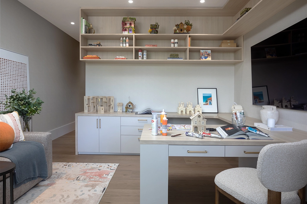 Bright craft room and creative workspace with custom shelving in a Coral Gables home.