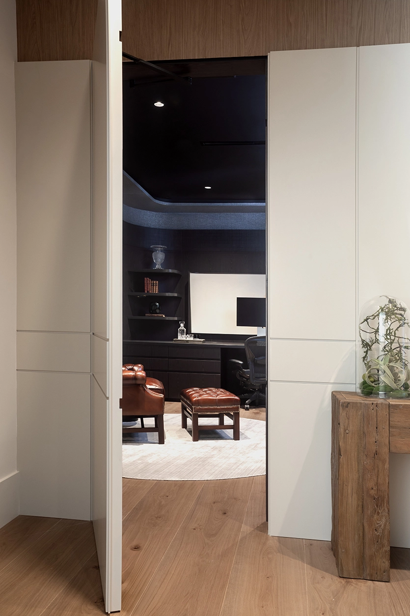 Entrance to a moody dark home office with sliding doors in a Coral Gables renovation.