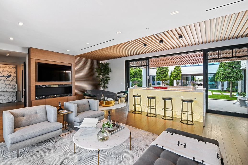 Glass doors connecting kitchen and patio in a Palm Beach indoor-outdoor design