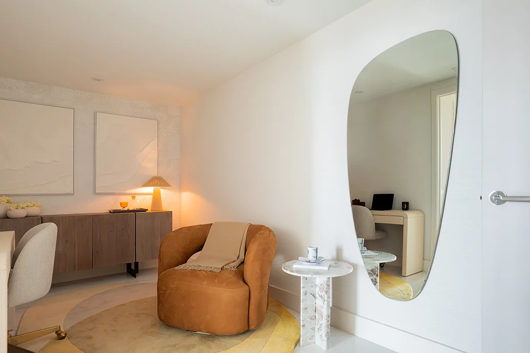 organic modern interior design home office with asymmetric mirror and rust armchair