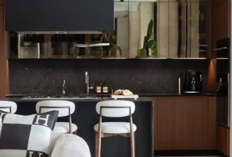 Existing kitchen with walnut cabinetry and dark marble connected to the bar and dining area, Miami Beach interior design