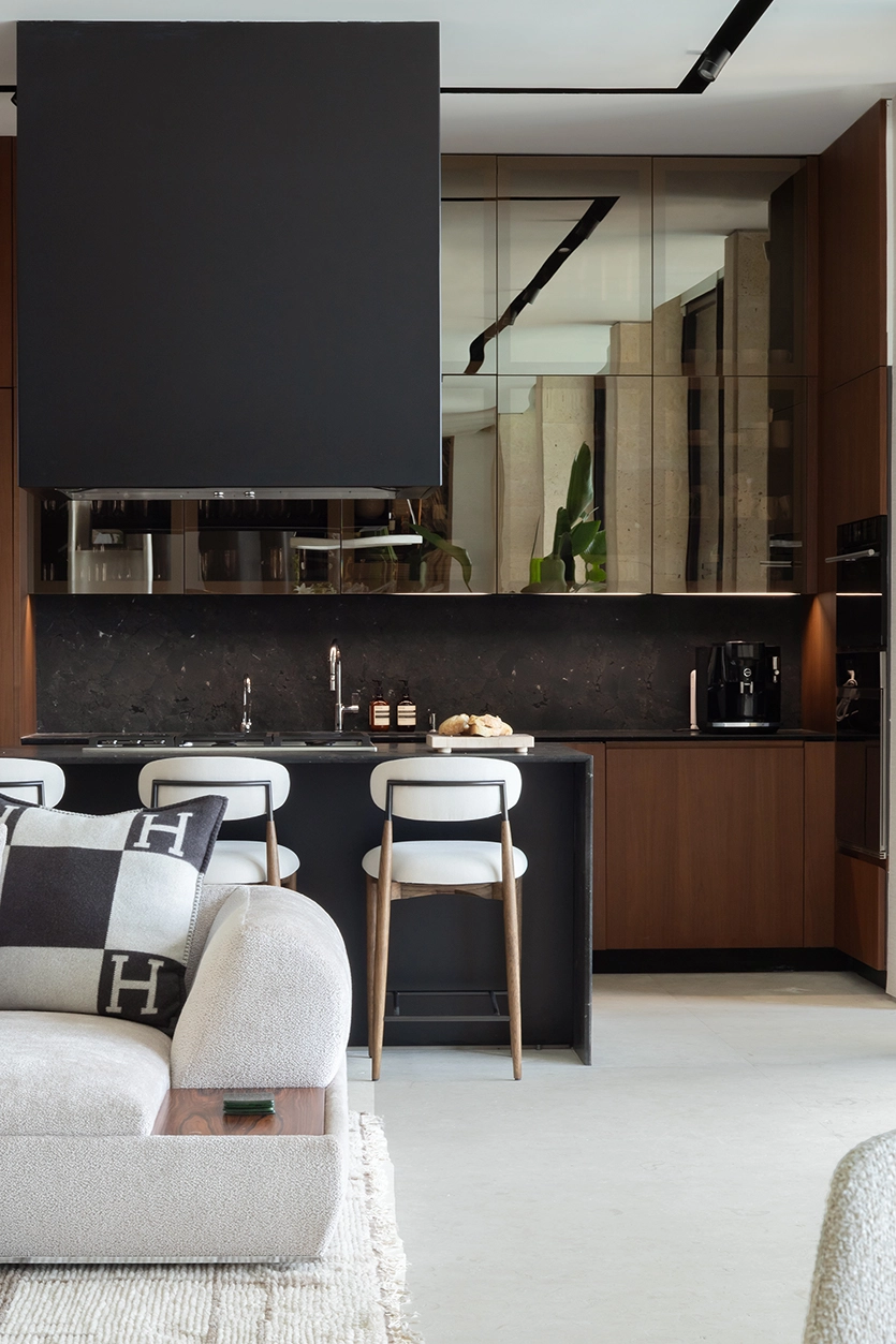Existing kitchen with walnut cabinetry and dark marble connected to the bar and dining area, Miami Beach interior design