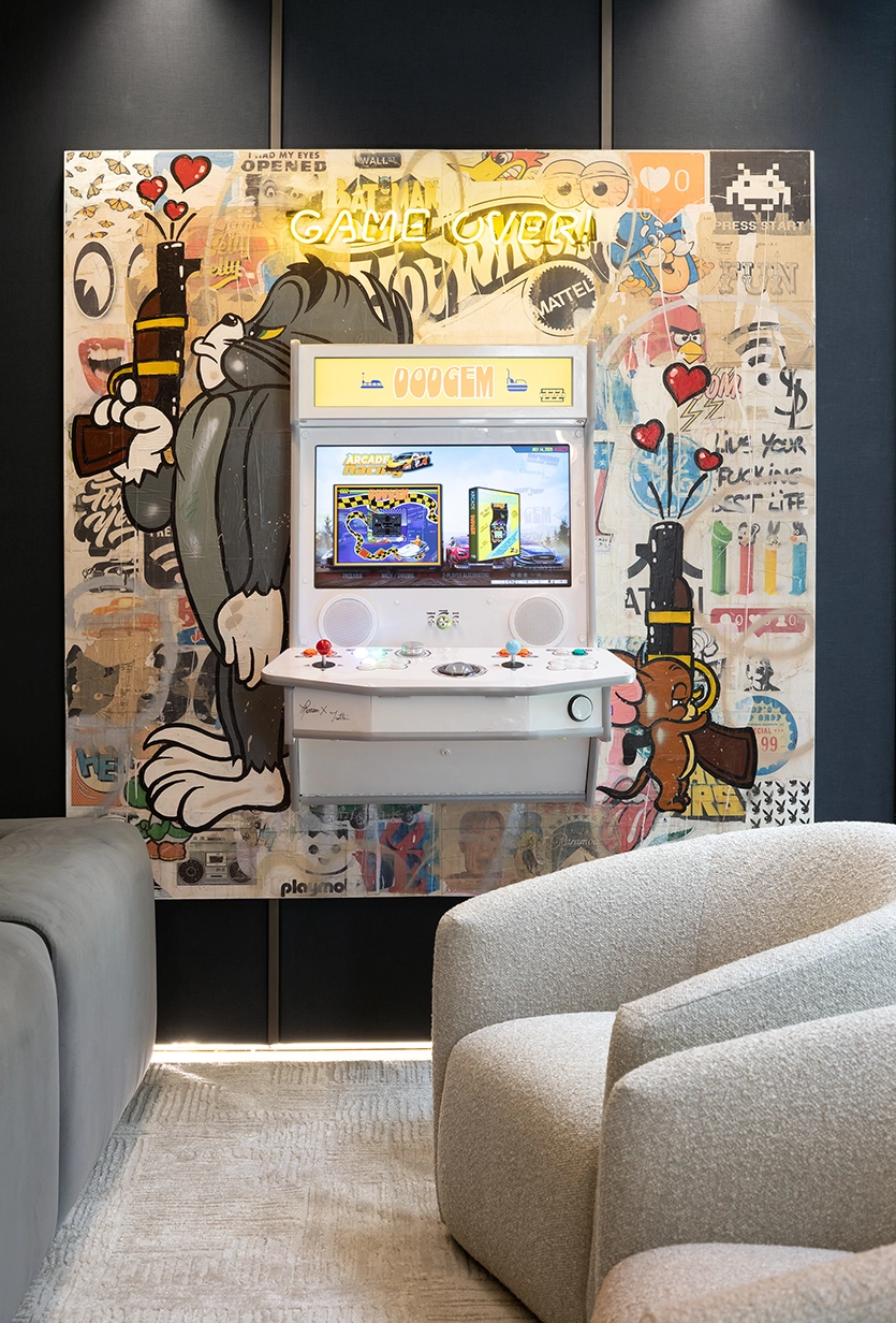 Pop-art arcade cabinet with neon sign in a golf simulator room, Miami Beach interior design
